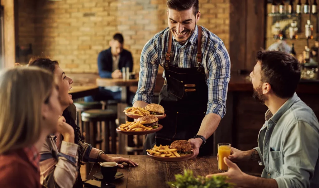 happy waiter serving food group cheerful friends pub 1410x830